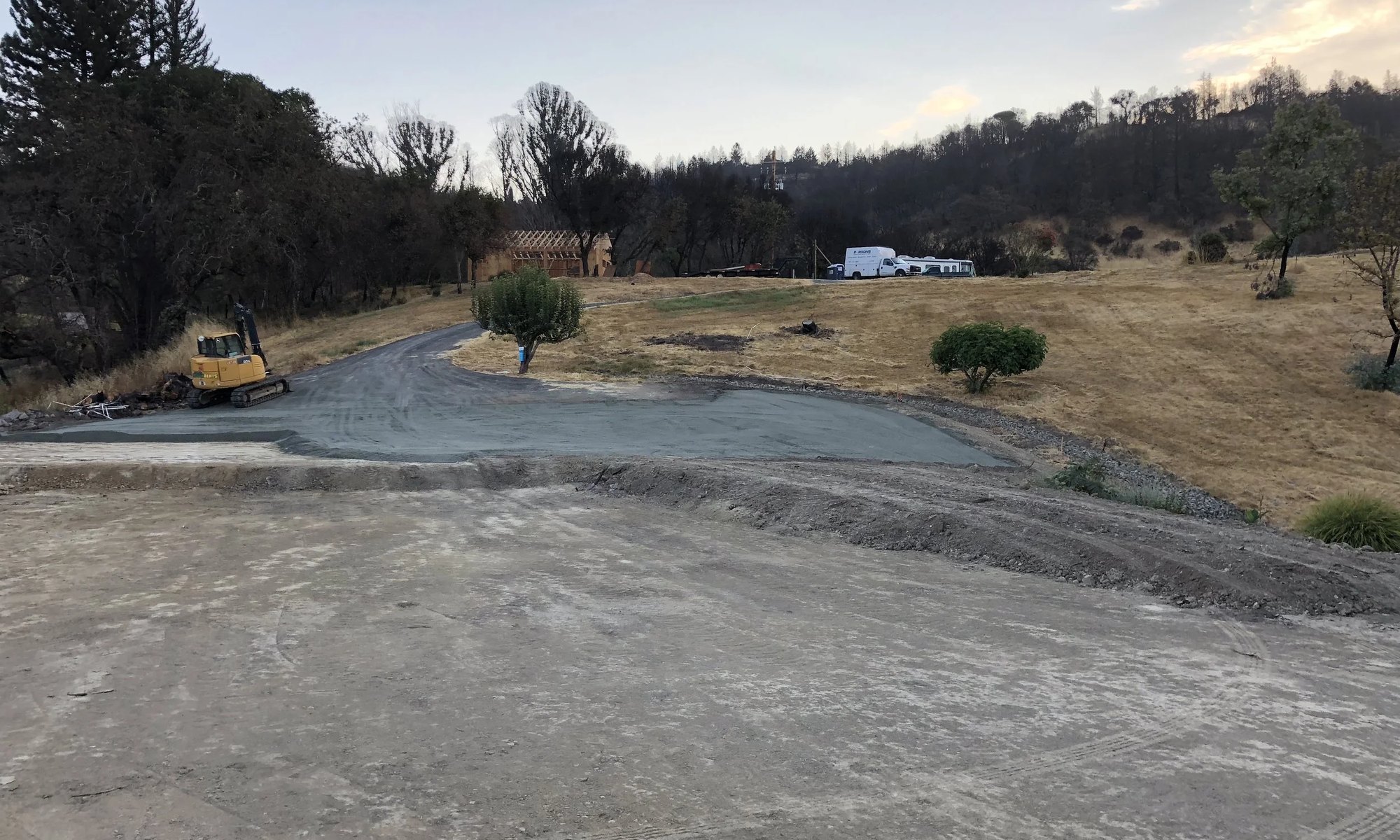 A graded building pad at dusk on a Daher Development site
